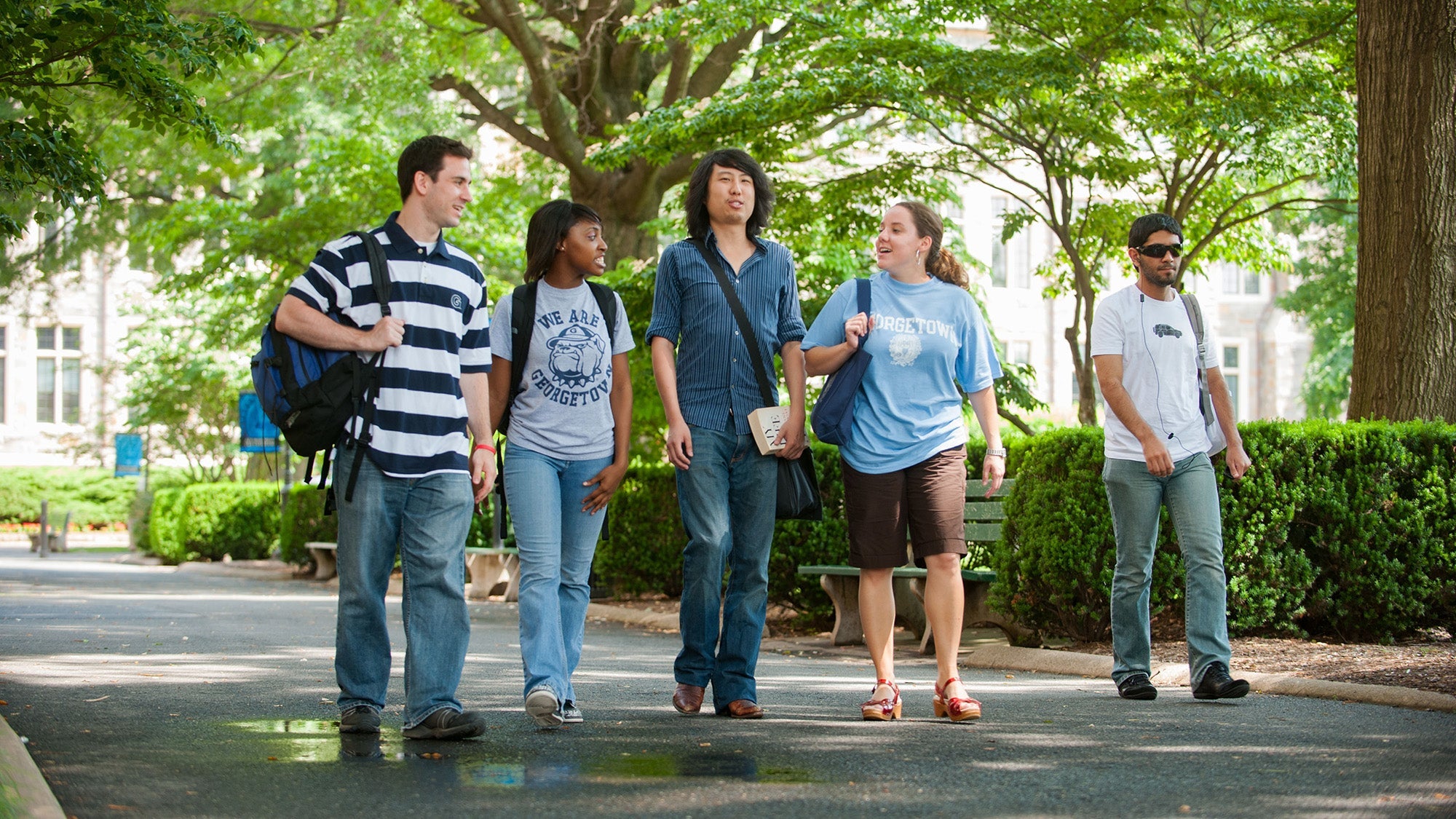 Five students walk together on campus