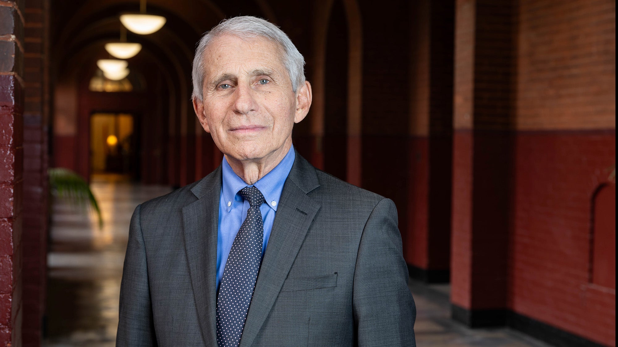 Anthony Fauci stands in a hallway at Georgetown