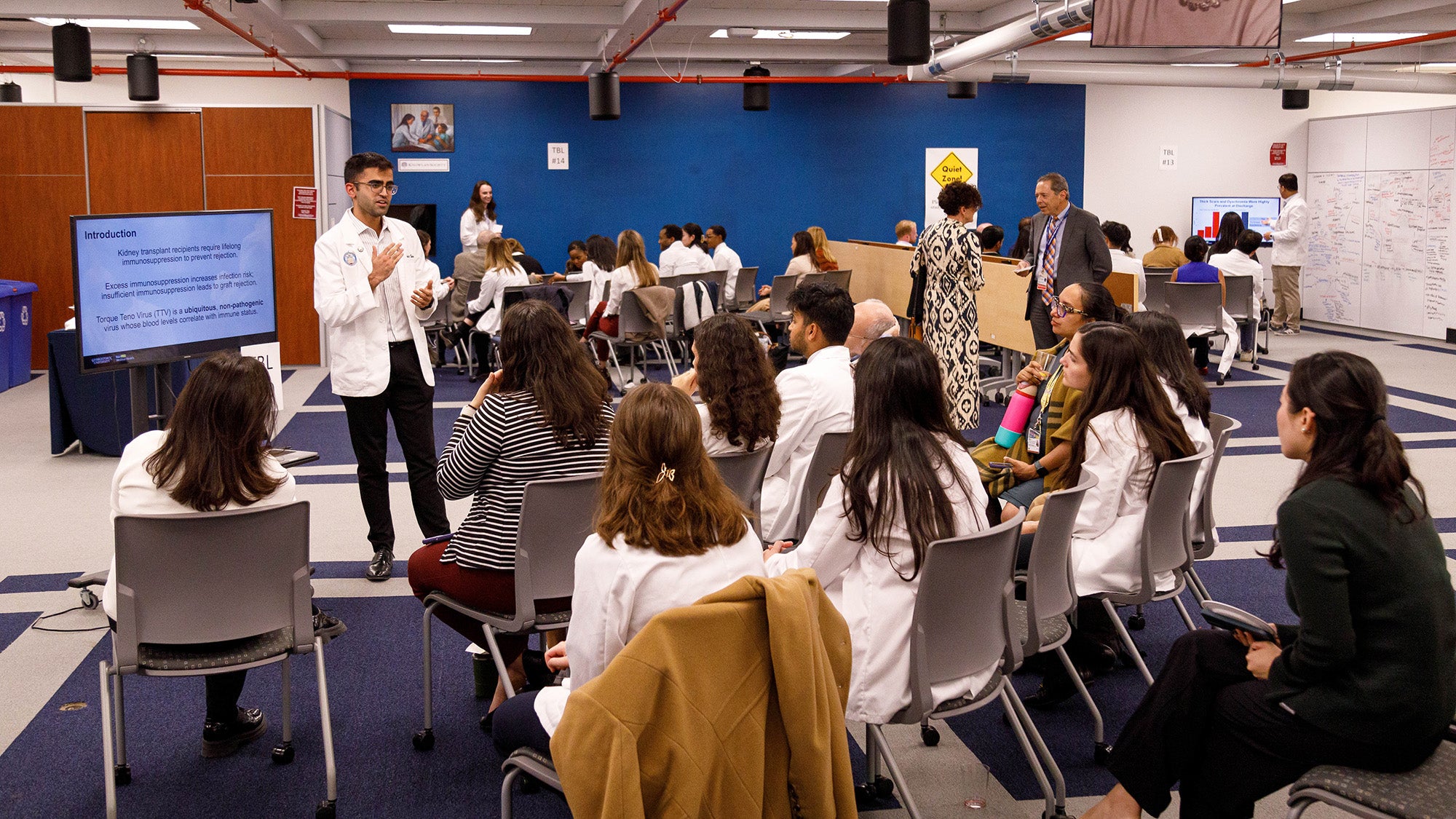 A room in DML is filled with student presenters and attendees