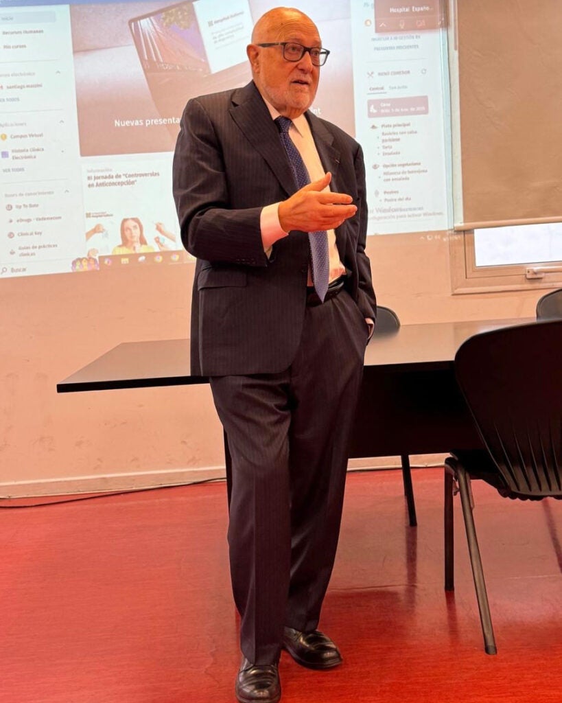 Carlos Pellegrini speaks from the front of a room