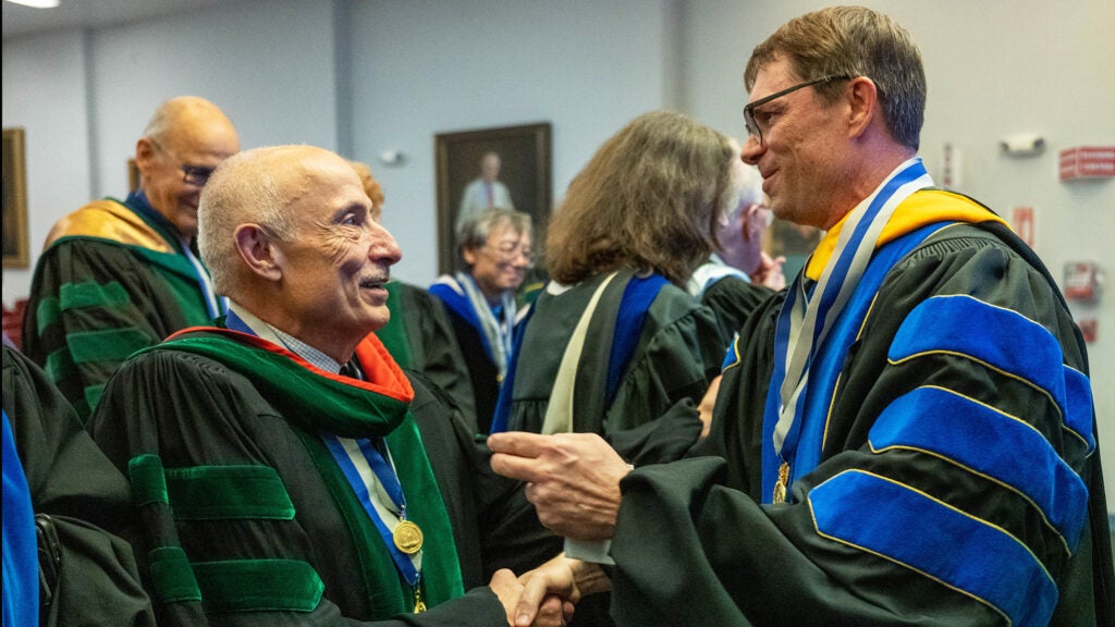 Dr. Haddad and Dr. Partridge shake hands