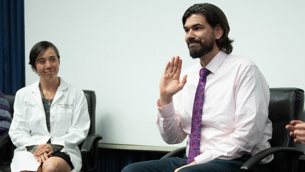 Shimae Fitzgibbons and Josh Watson sit side by side onstage