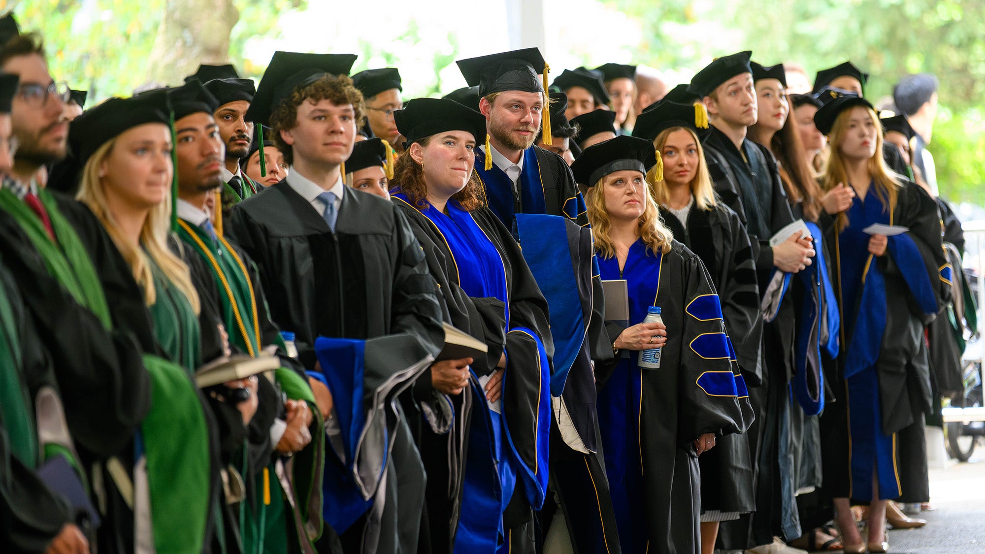 Graduates stand together in a line