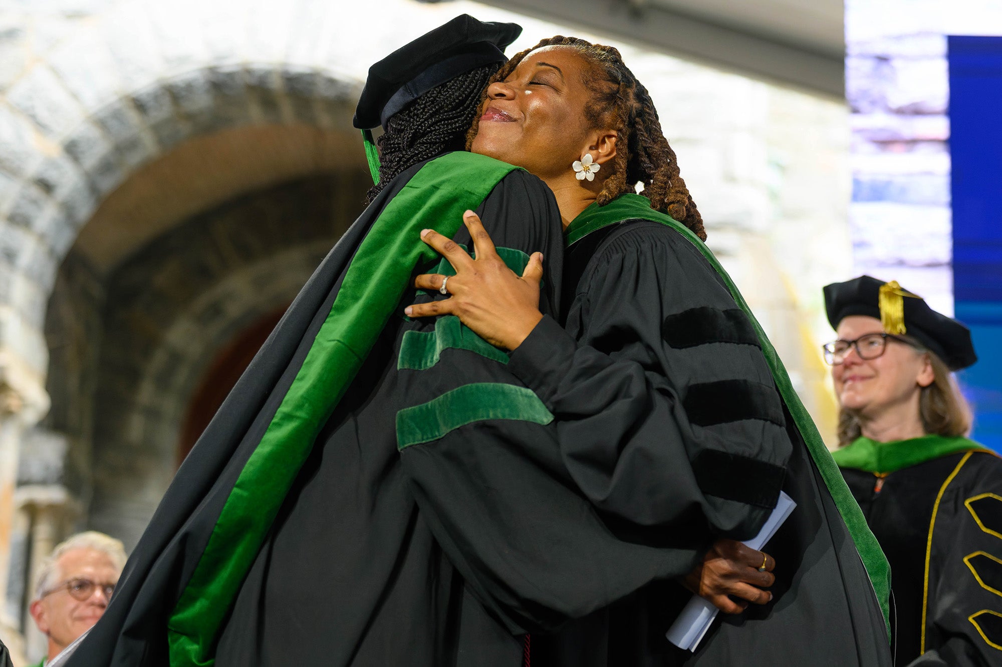 Two med grads hug