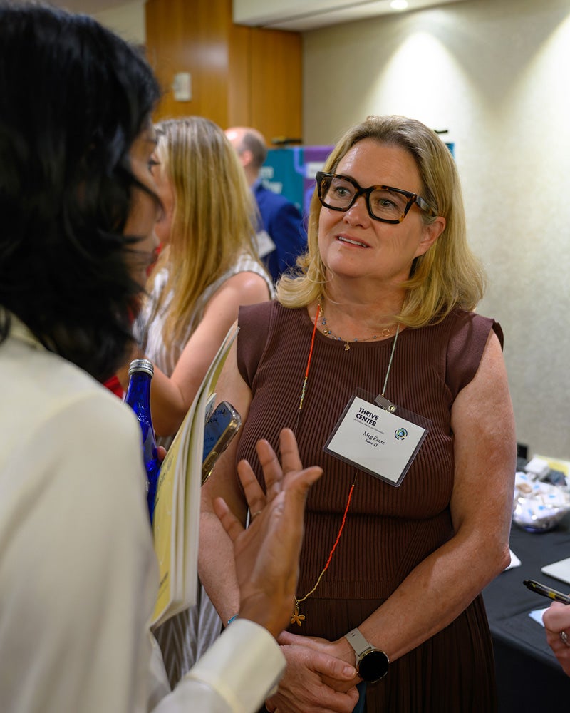 Meg Faure speaks to a person at the solutions fair
