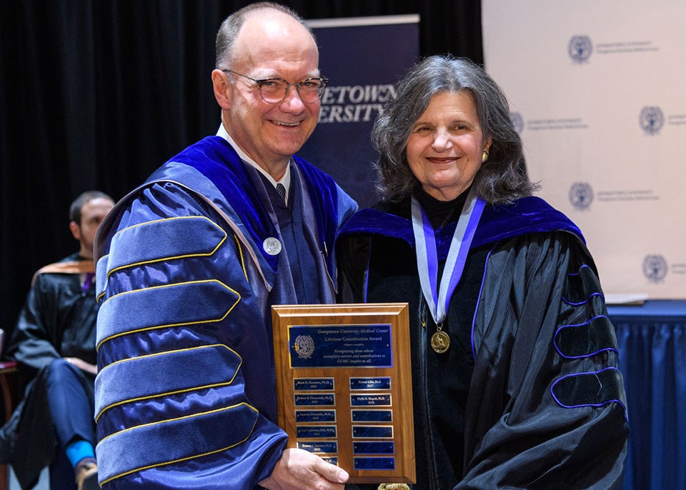 John J. DeGioia and Phyllis Magrab with the plaque honoring her at convocation