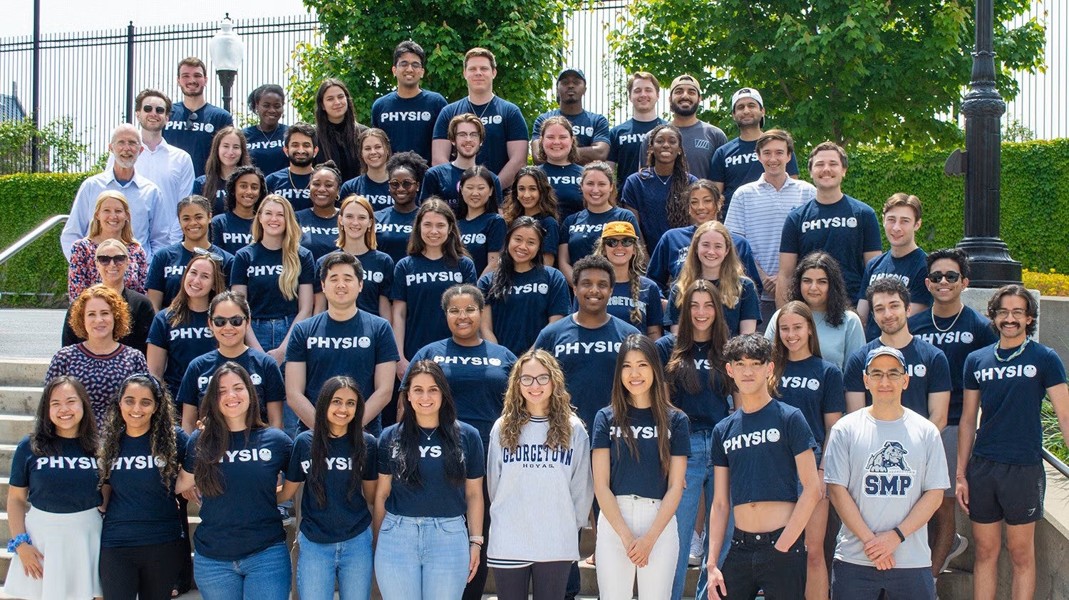 A large group of students wearing matching Physio T-shirts stands together