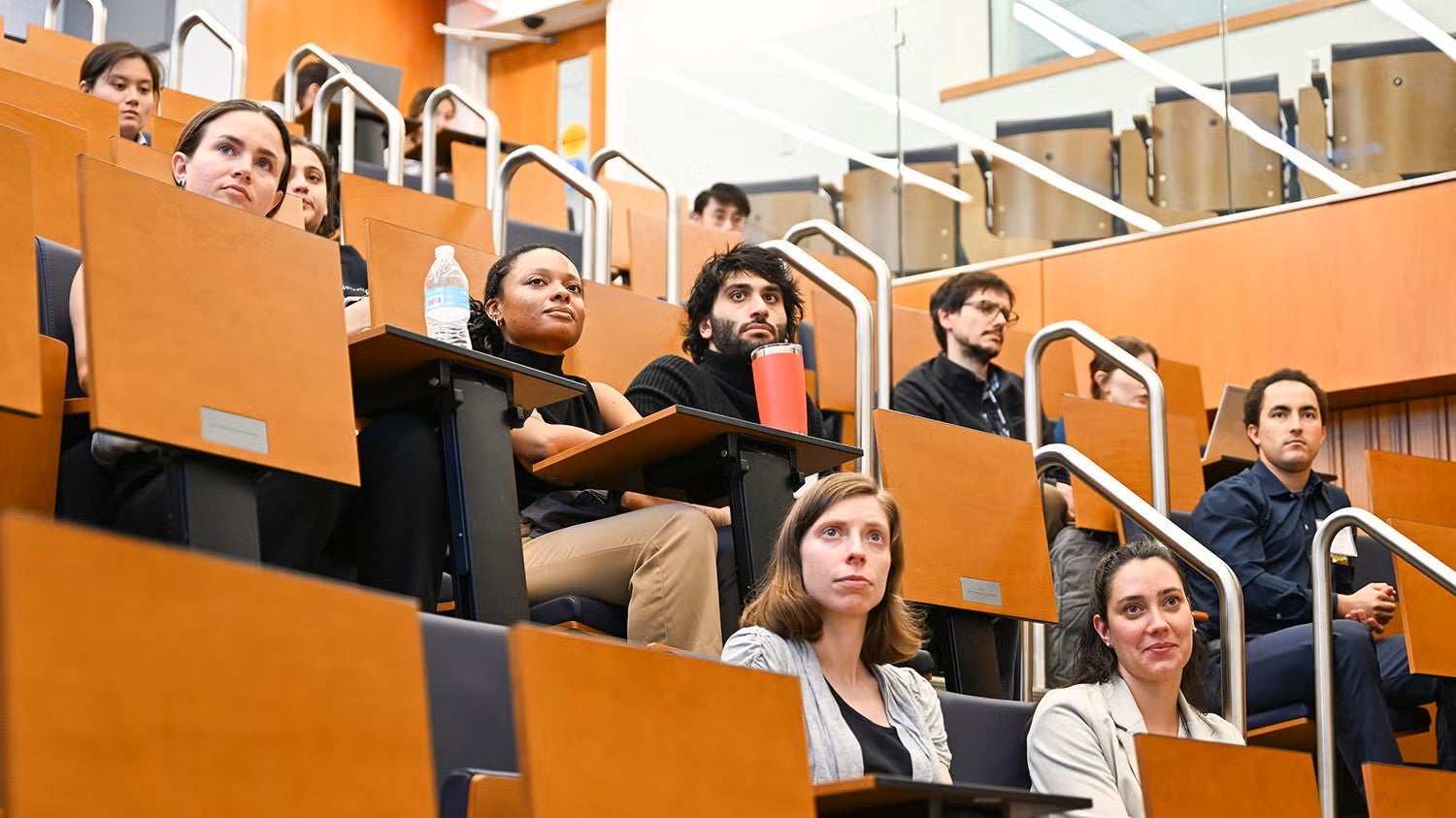 Students sit in seats in the Proctor Harvey lecture hall in the School of Medicine's Med-Dent Building